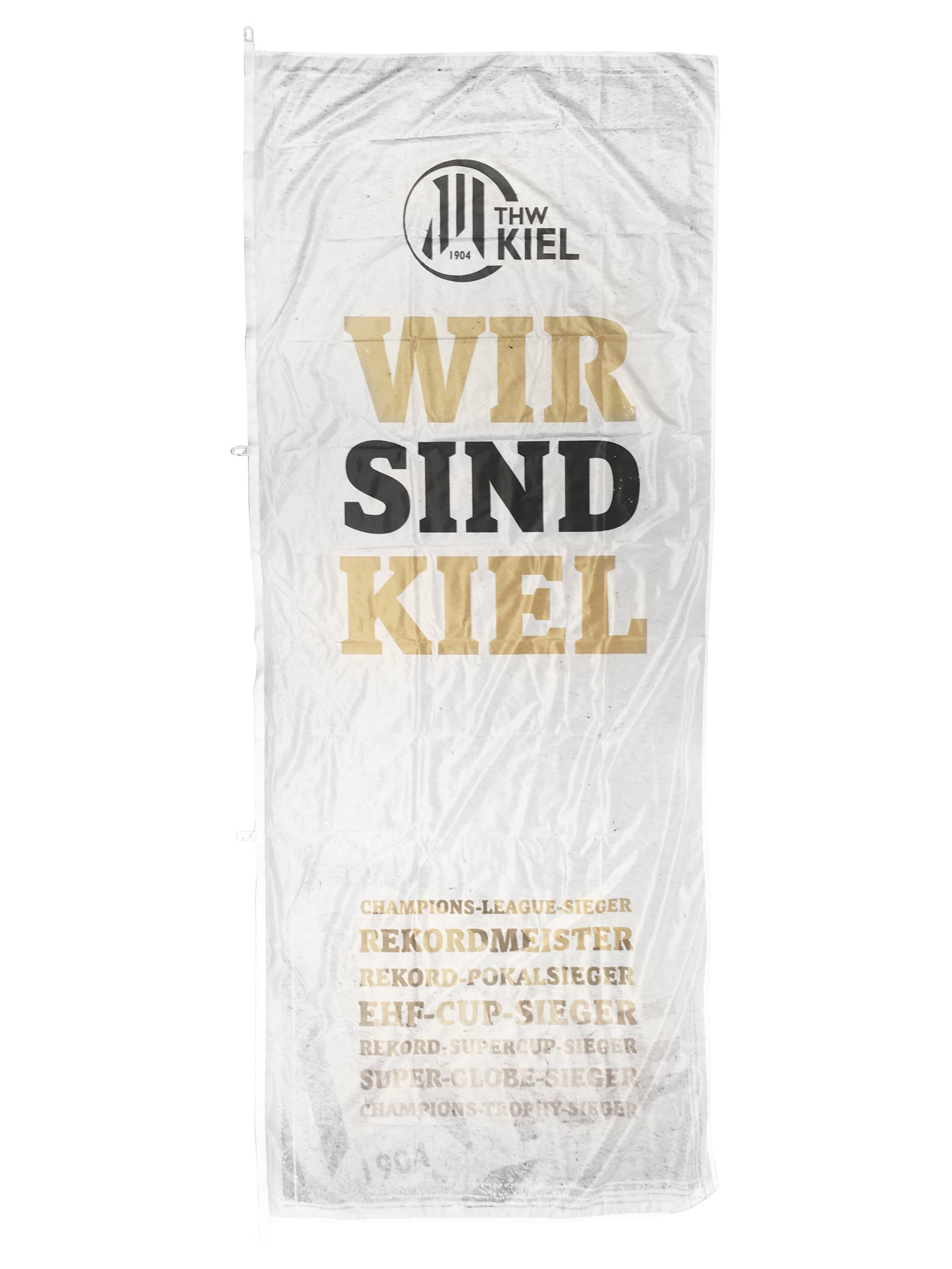 Die Fahne WIR SIND KIEL/Titel (120 x 300cm, weiß) zeigt oben das THW Kiel-Logo, unten in Schwarz-Gold den Schriftzug "Wir sind Kiel" und eine goldene Auflistung von Titeln und Erfolgen zu Ehren der Handball-Rekordmeister.