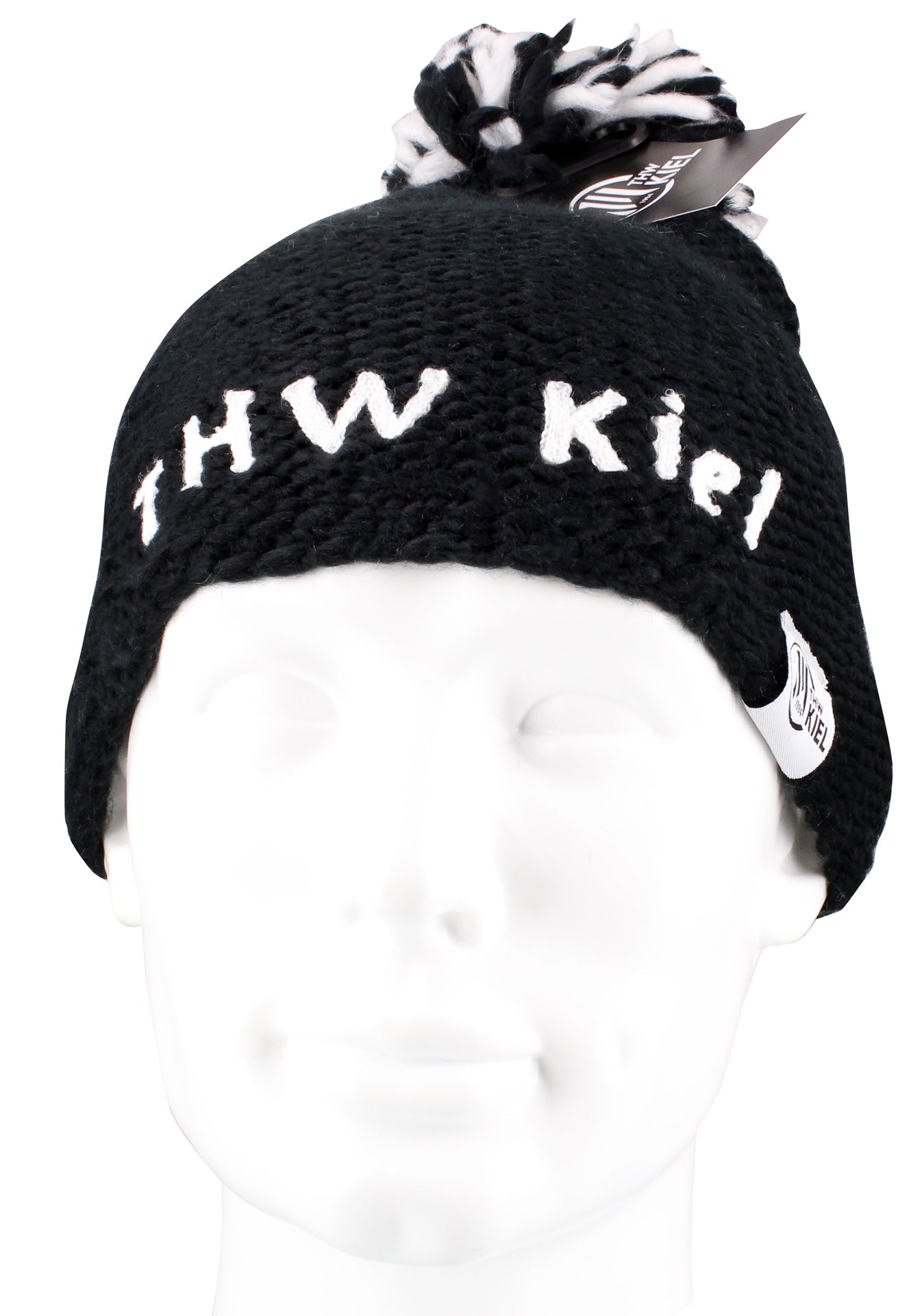 Die Pudelmütze THW KIEL gestrickt schwarz ist eine schwarze Strickmütze mit schwarz-weißem Bommel und weißem Schriftzug "THW Kiel" auf der Vorderseite - ideal für Handballfans. Ausgestellt auf einem weißen Schaufensterkopf.
